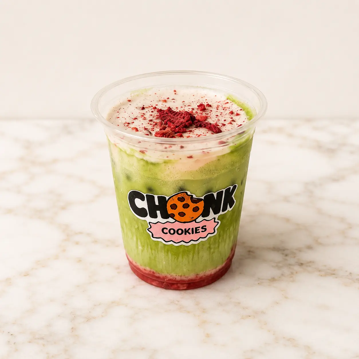 Strawberry Matcha in a CHONK cup with layered strawberry syrup and cold foam